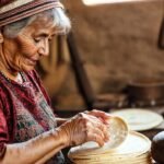 Una anciana cocina tortillas con belleza simple